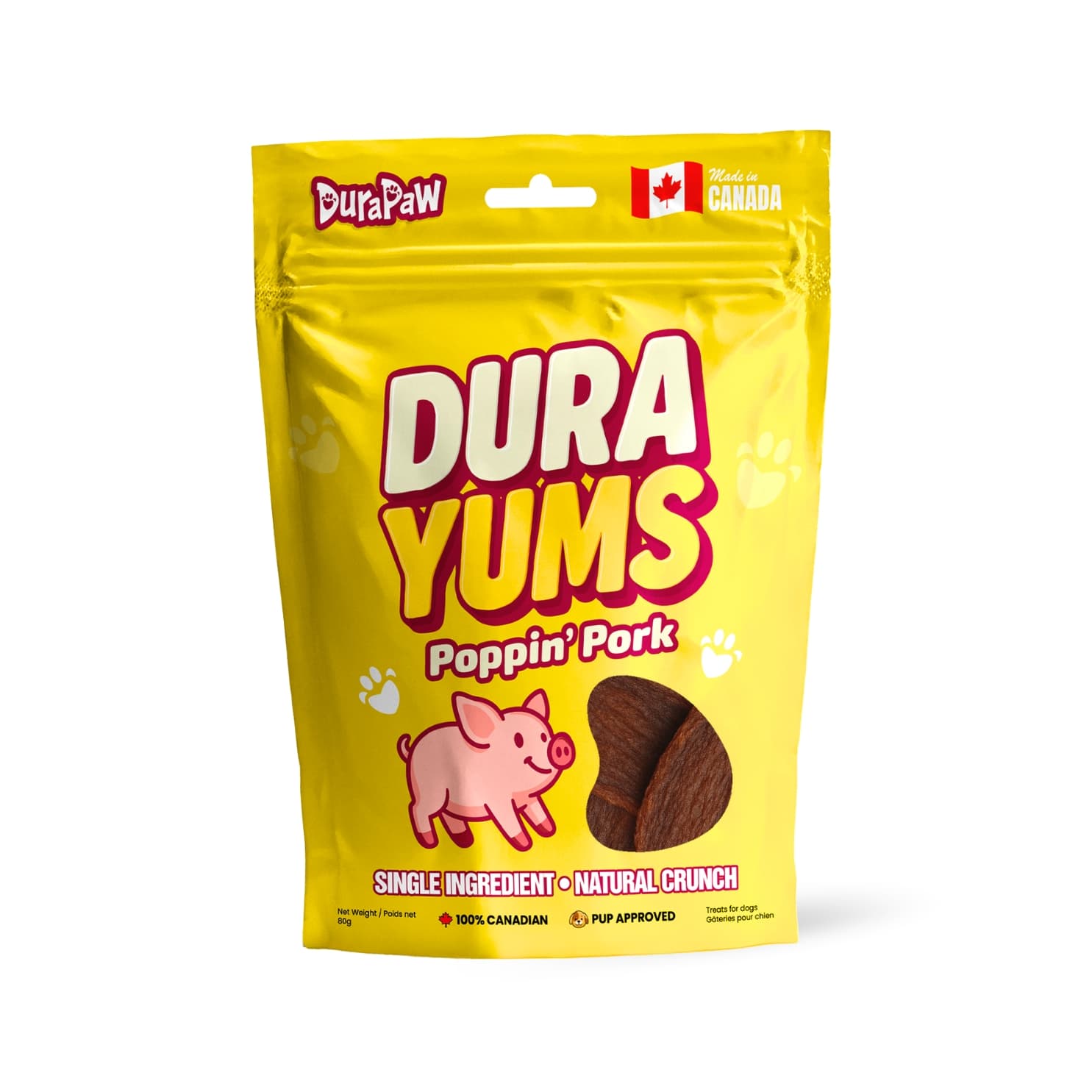 Bright yellow bag of DuraYums Poppin' Pork dog treats featuring a playful pig illustration, "DURA YUMS" branding in bold letters, Canadian flag, and highlights like "Single Ingredient" and "Natural Crunch.